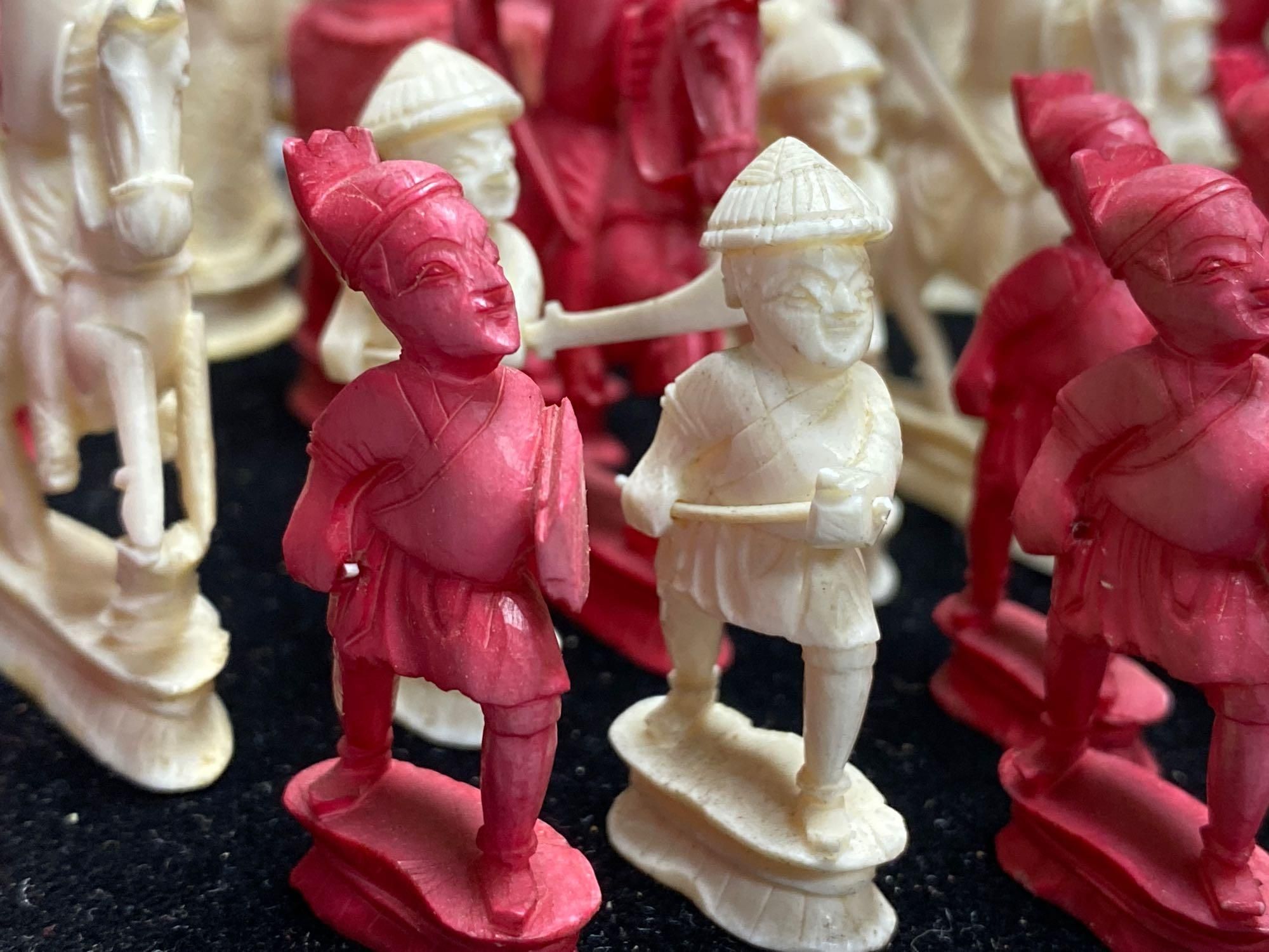 A 19th century Chinese ivory chess set, on a circular mahogany plinth, under glass dome, kings 10cm, dome 38cm
